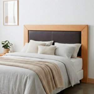 Respaldo para cama modelo Haven con marco de madera clara y panel central acolchado en eco-cuero marrón oscuro con costuras blancas, sobre fondo blanco liso.